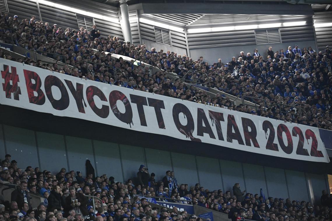Football fans display a large banner reading 'Boykott Qatar' with reference to the 2022 FIFA Football World Cup to be played in Qatar, during the German first division Bundesliga football match between Schalke 04 v Bayern Munich in Gelsenkirchen, western Germany, on November 12, 2022. (Photo by UWE KRAFT / AFP) / DFL REGULATIONS PROHIBIT ANY USE OF PHOTOGRAPHS AS IMAGE SEQUENCES AND/OR QUASI-VIDEO